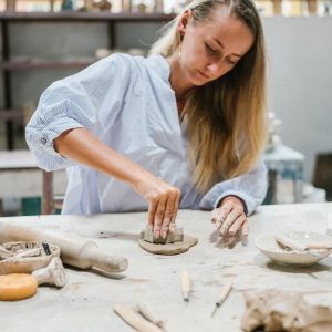 Woman working with clay in a pottery studio
