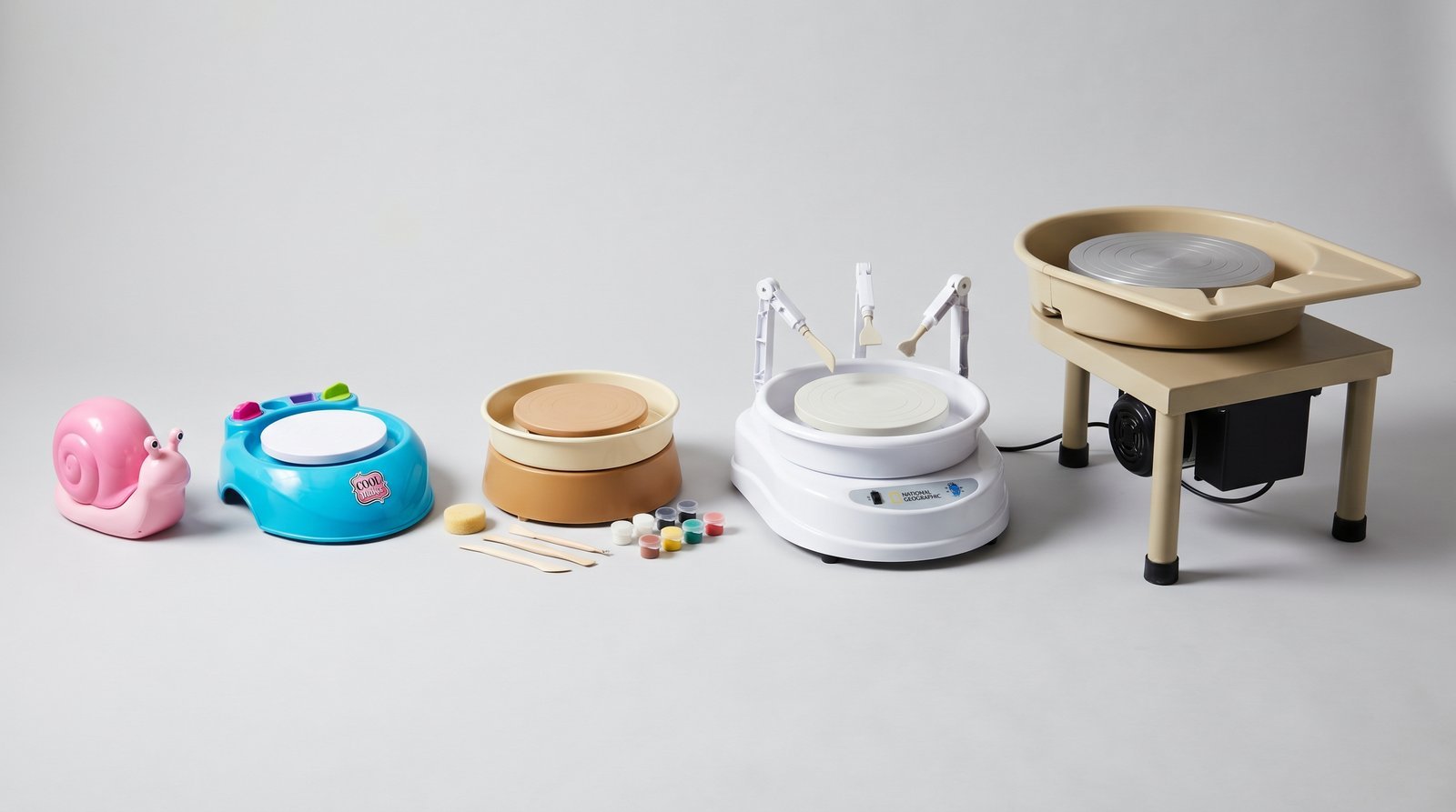 Five pottery wheels for kids 2026 lineup showing size progression from small pink toy snail wheel to large adult Speedball Artista style pottery wheel